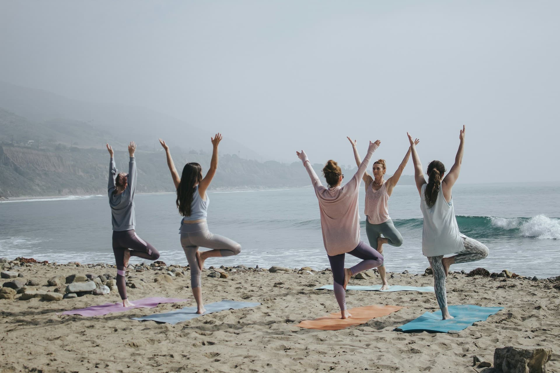 People practicing yoga together in a light-filled space